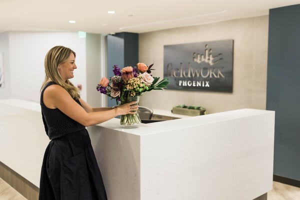 Fieldworker placing flowers on front desk